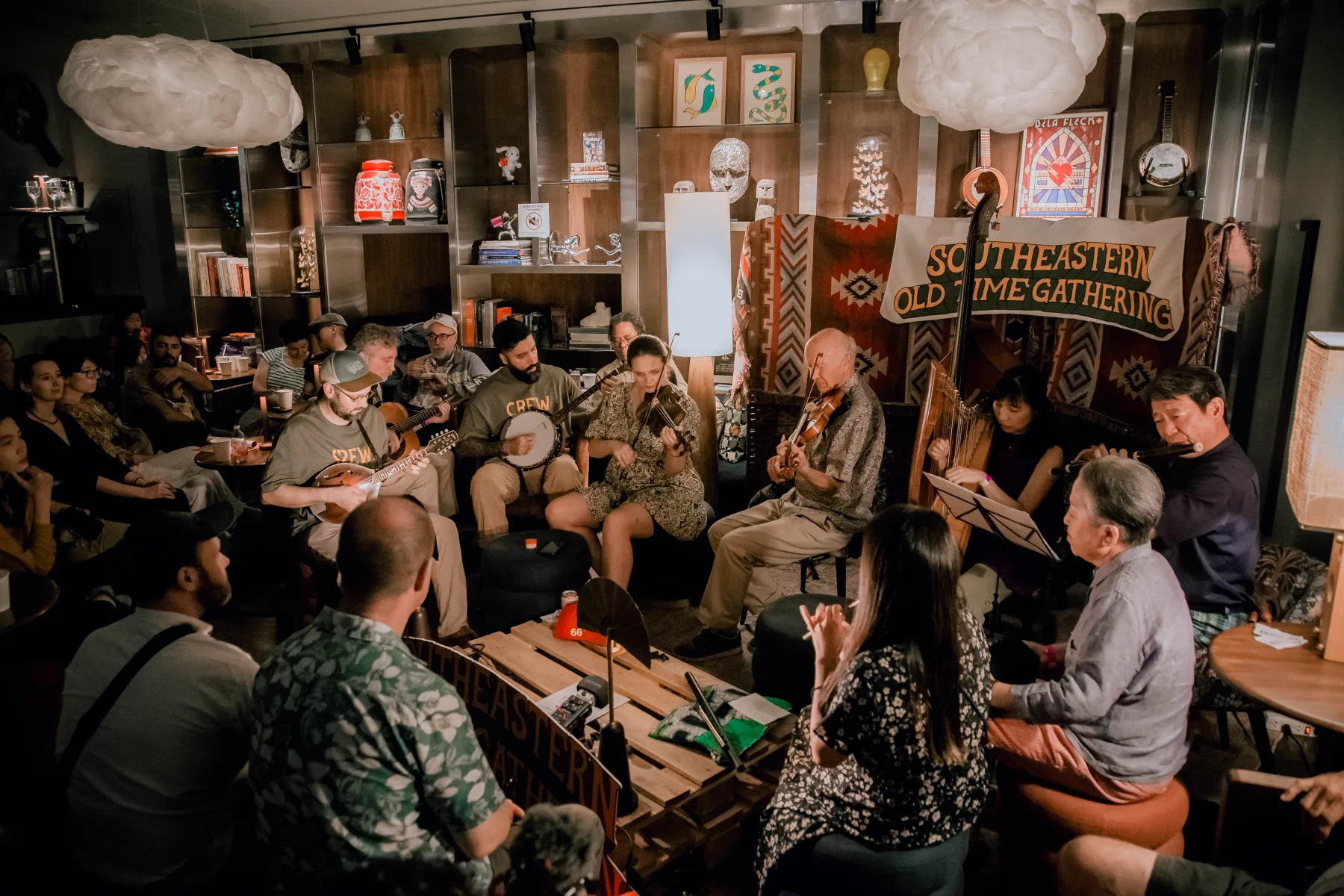 Dense multi-instrument circle filling the Public House listening room