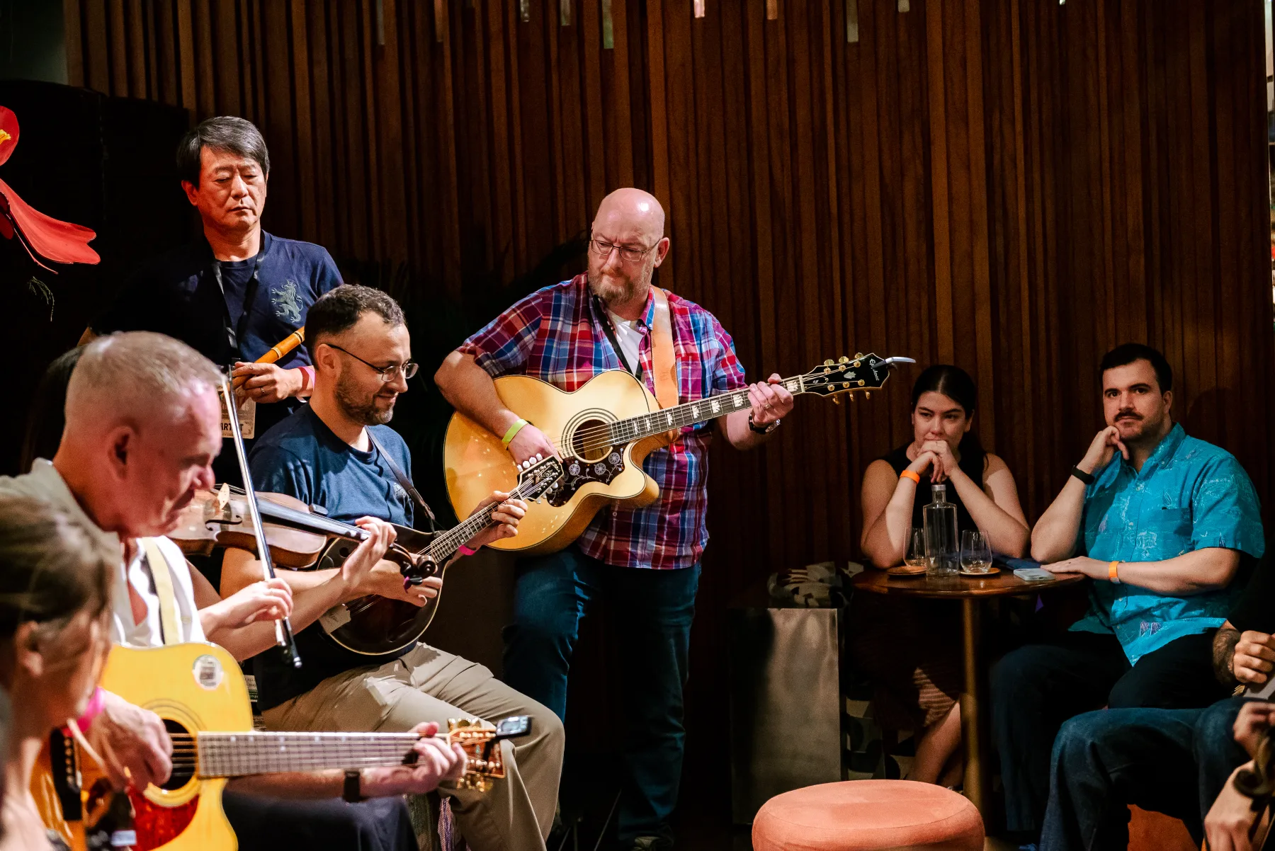Guitars, banjo and fiddle entering a close jam from several directions